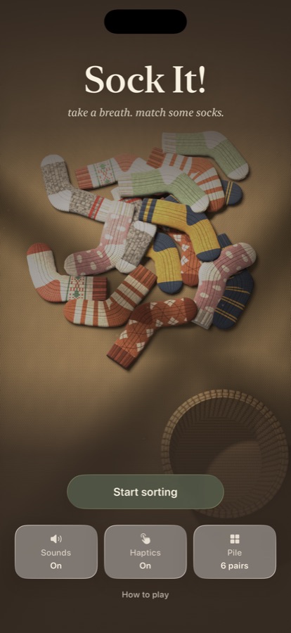 The home screen: a pile of knitted socks on a wooden table