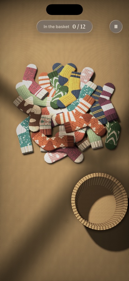 Gameplay: twelve pairs of socks waiting to be matched, with a laundry basket